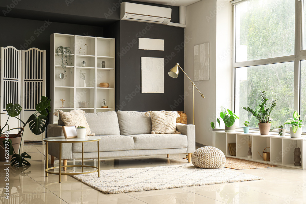 Interior of modern living room with grey sofa and coffee table