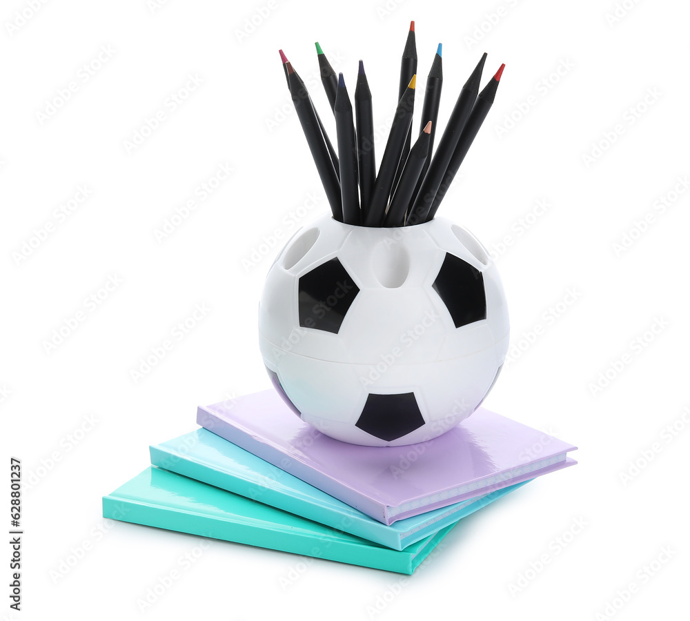 Cup in shape of ball with school stationery and notebooks on white background