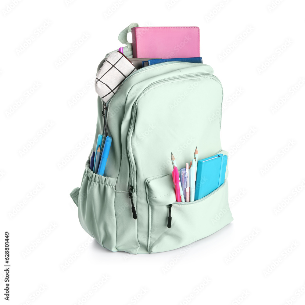 Green school backpack with notebooks, pencils case and pens on white background