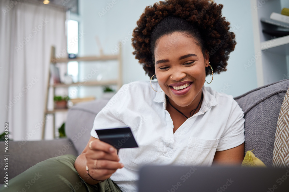 Happy black woman, laptop and credit card for ecommerce, payment or banking on sofa at home. African