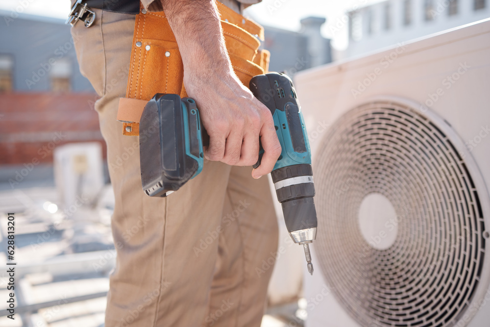 Hands, man and outdoor for air conditioner maintenance, roof and building in city, drill or construc