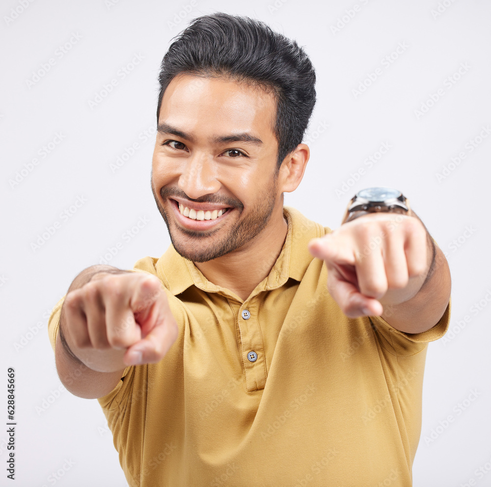 Portrait, smile of Asian man and pointing to you in studio isolated on a white background. Face, hap