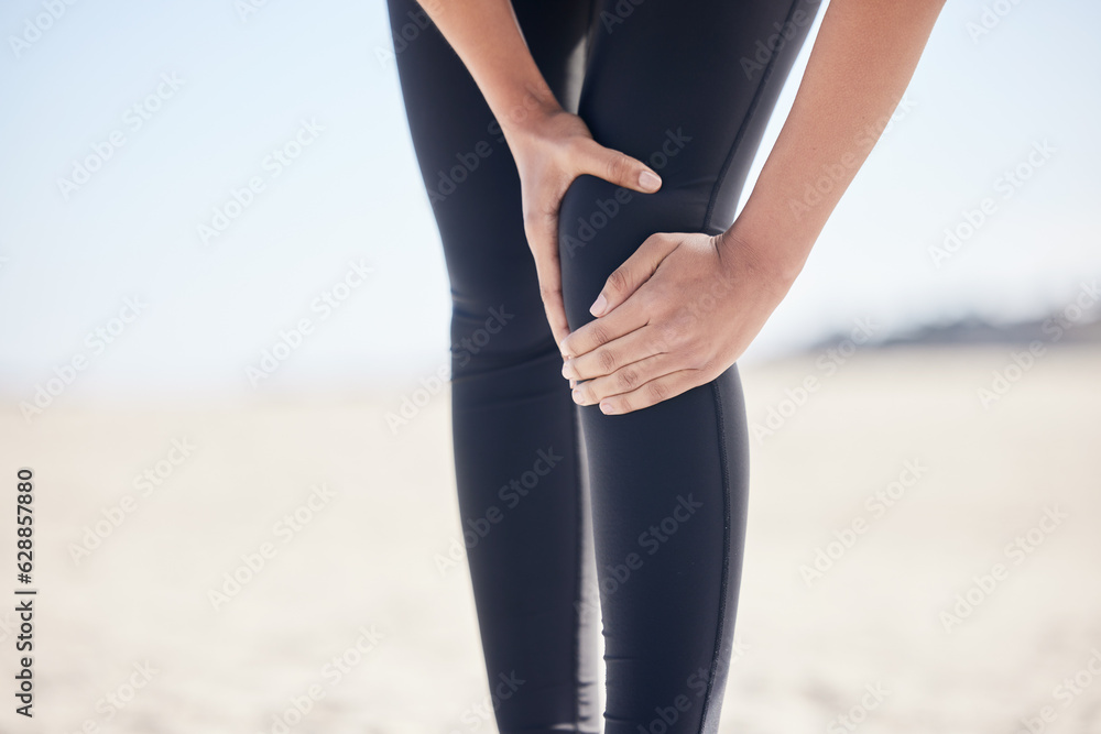 Fitness, knee pain and running with woman on beach for sports injury, inflammation and accident. Eme