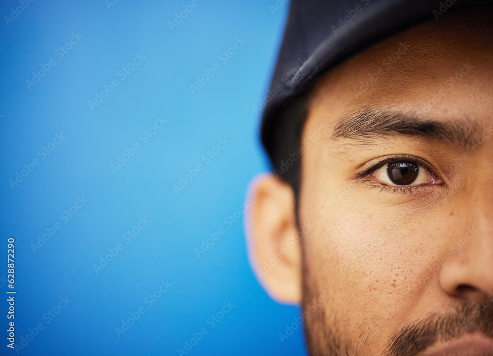 Eye, closeup and portrait of half of man in sports on blue background with advertising, mockup or sp