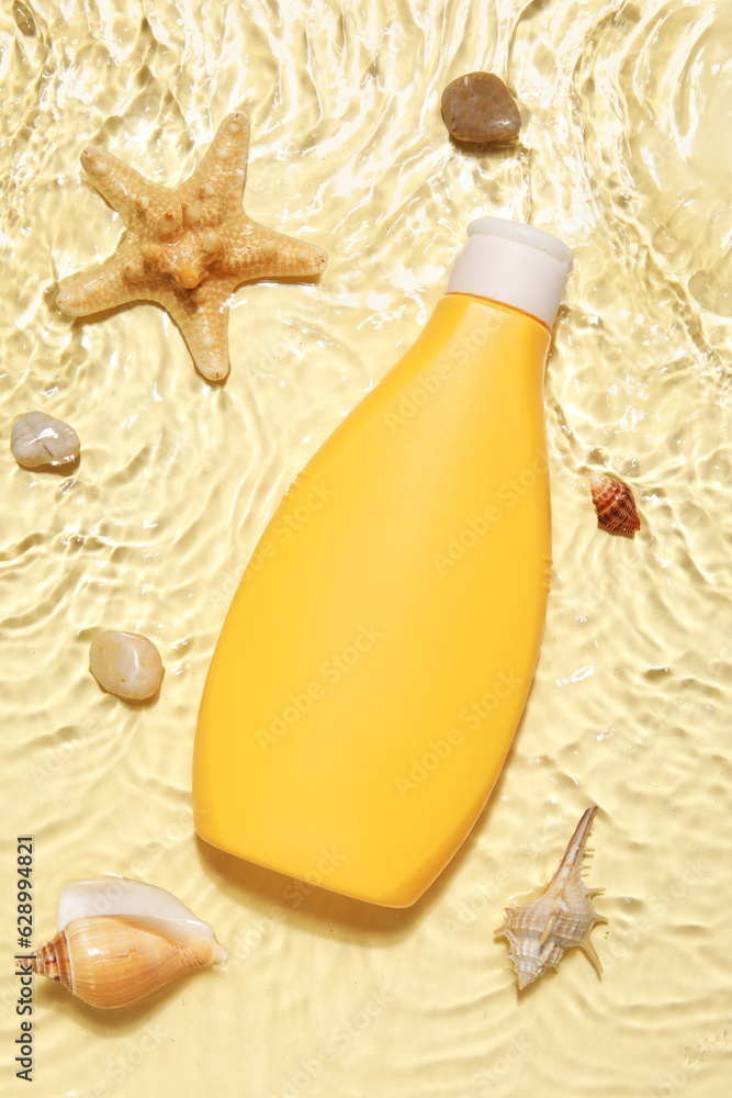 Sunscreen cream with starfishes and seashells in water on color background