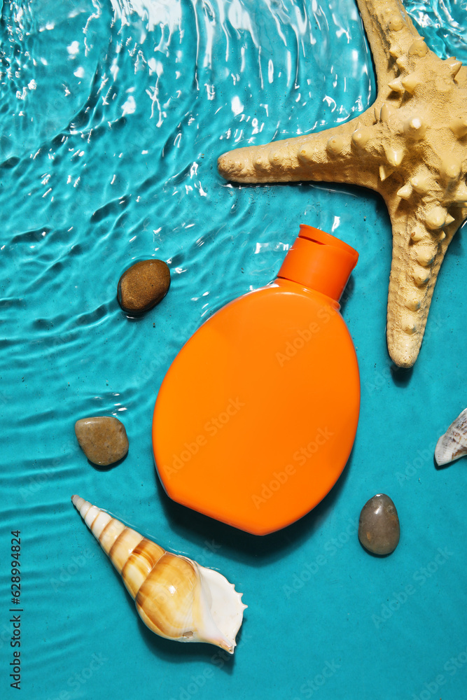 Sunscreen cream with starfishes and seashells in water on color background