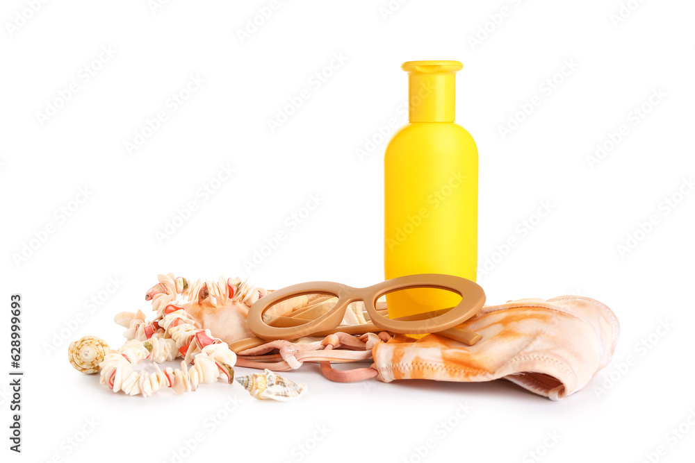 Sunglasses with seashells necklace, swimsuit and bottle of sunscreen cream isolated on white backgro