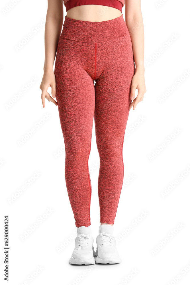 Sporty young woman in leggings on  white background