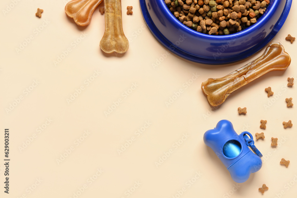 Composition with dry dog food, treats and waste bags on color background