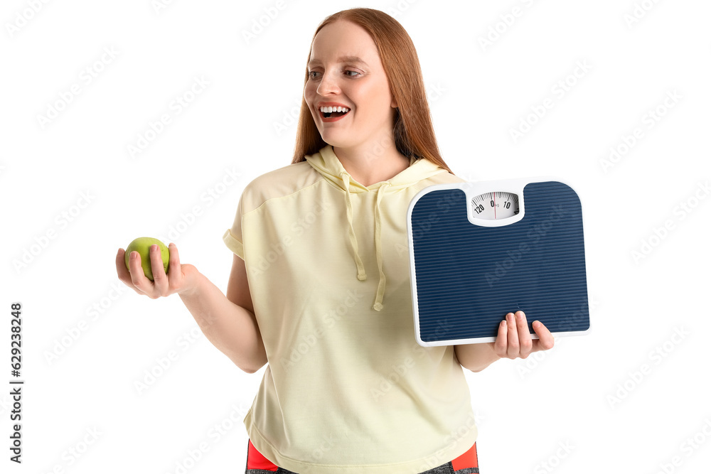 Young overweight woman with scales and apple on white background