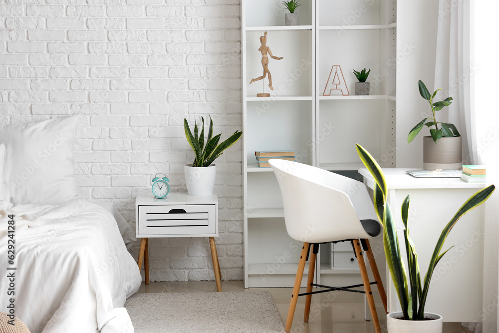 Interior of light childrens bedroom with white desk near window