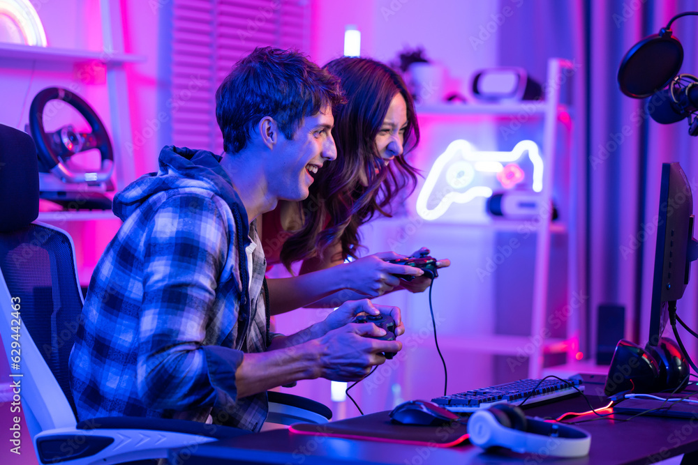 Caucasian Esport couple gamer playing online video game on computer. 