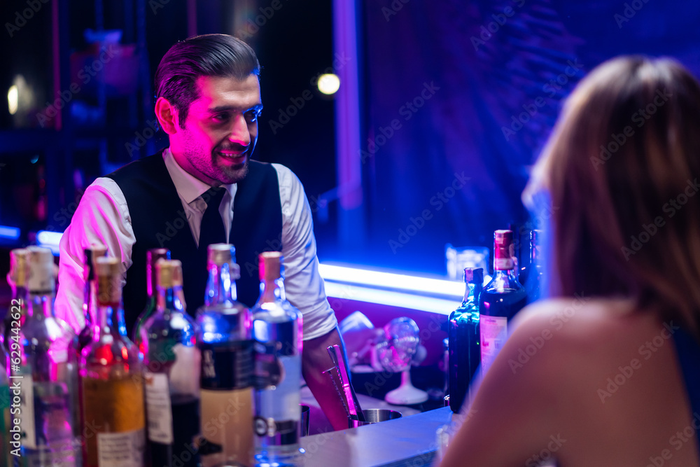 Caucasian profession bartender making a cocktail for women at a bar. 