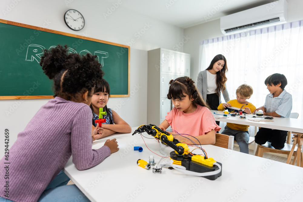 Caucasian woman teacher teaching a lesson to kids at elementary school. 