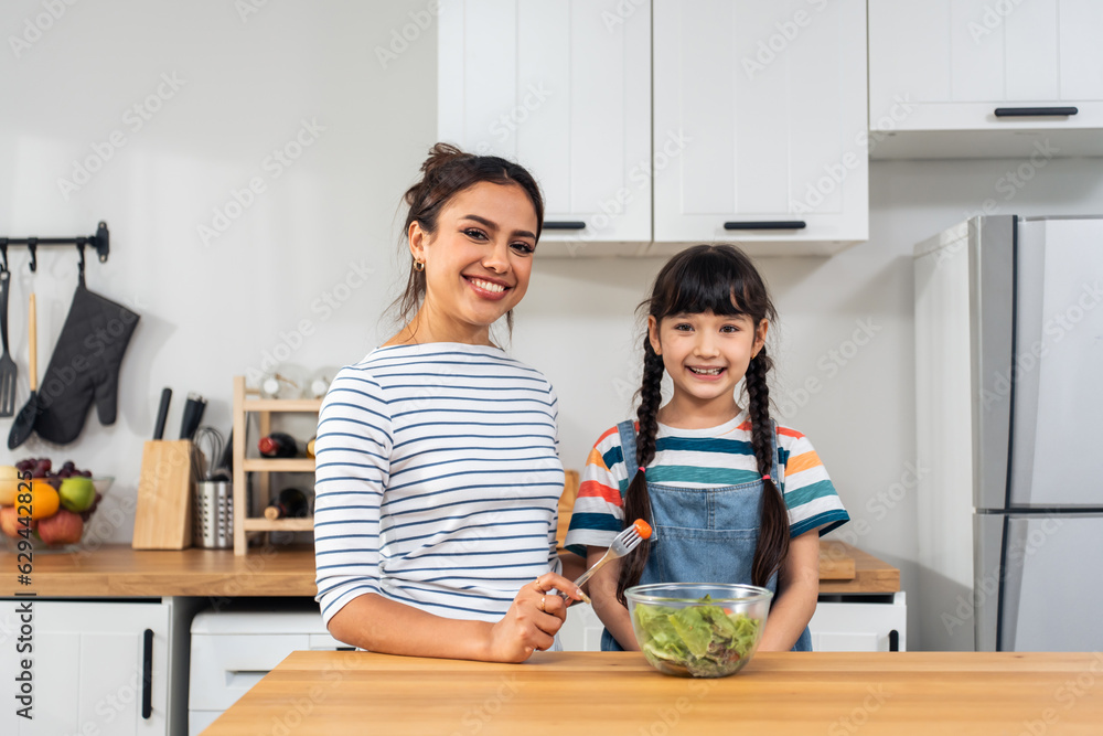 Portrait of Caucasian mother and young girl child looking at camera. 