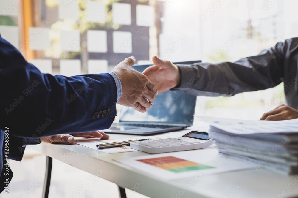 Business people shaking hands in a successful financial and investment cooperation meeting.