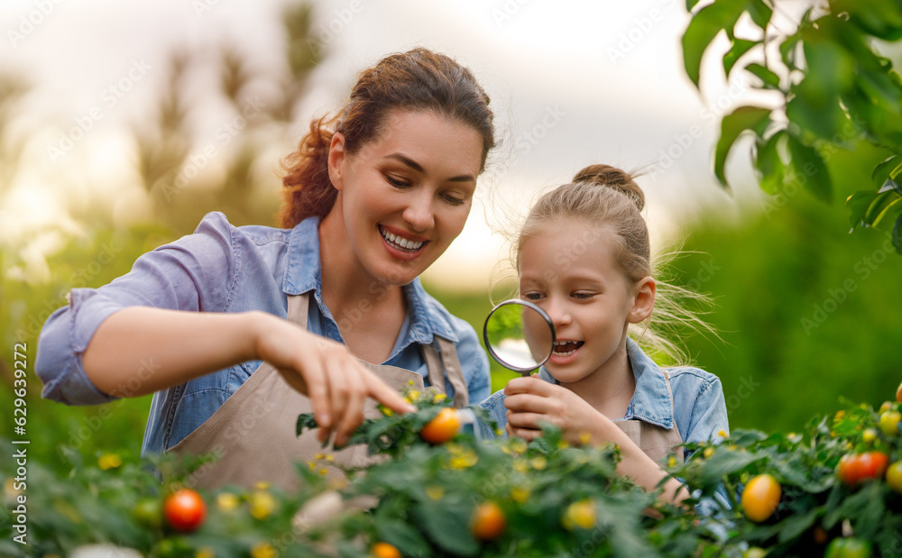 mother and daughter gardening in the backyard