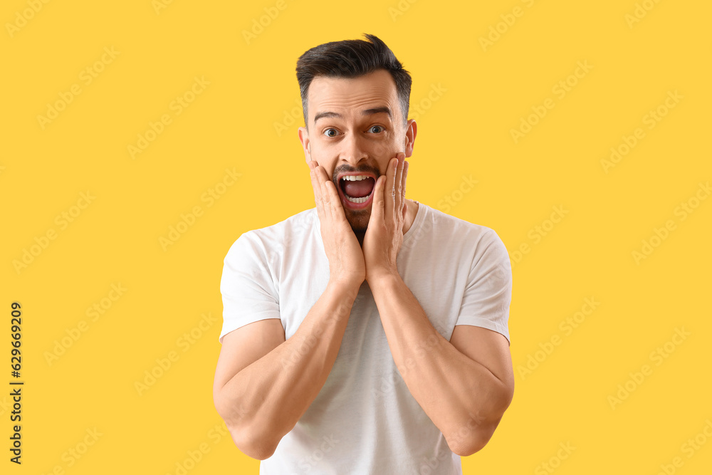 Scared man with hair loss problem on yellow background