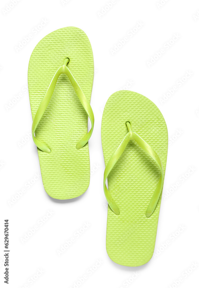 Pair of green flip-flops on white background