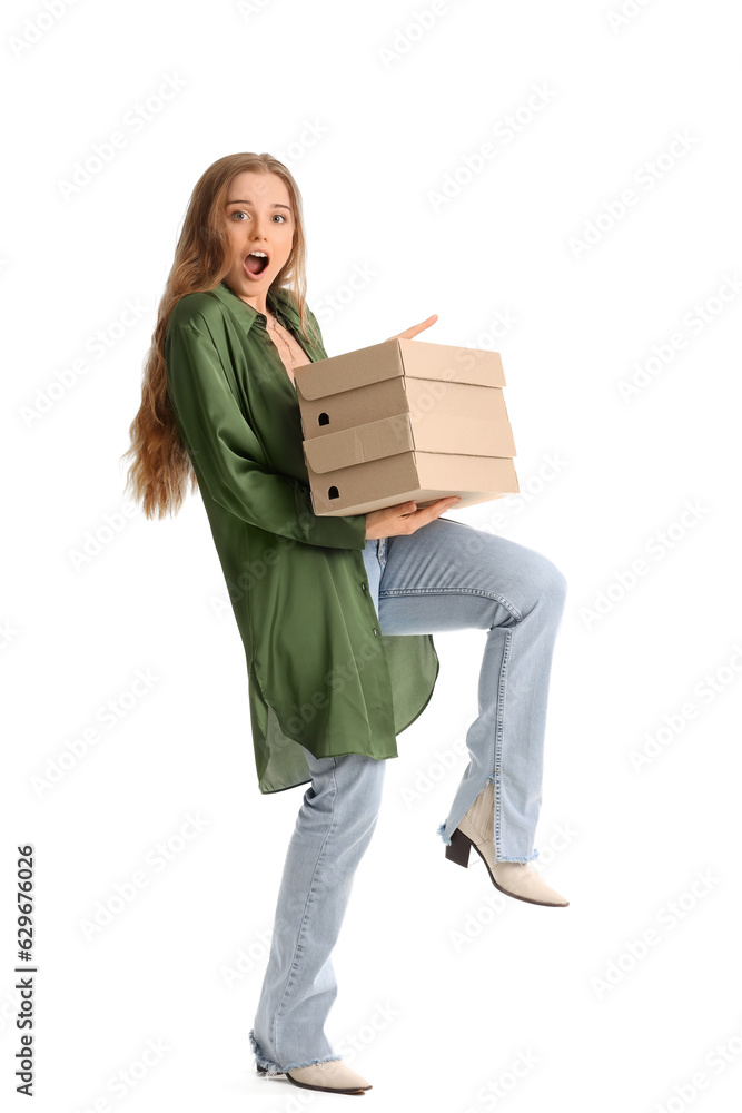 Shocked young woman with shoe boxes on white background