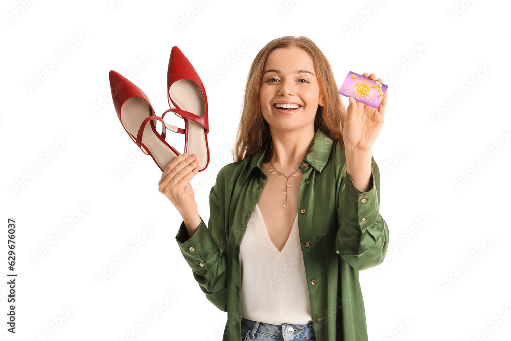 Young woman with stylish shoes and credit card on white background