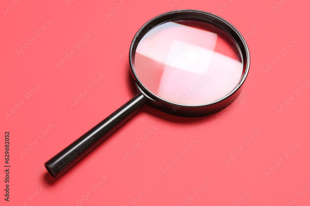 Black magnifier on red background