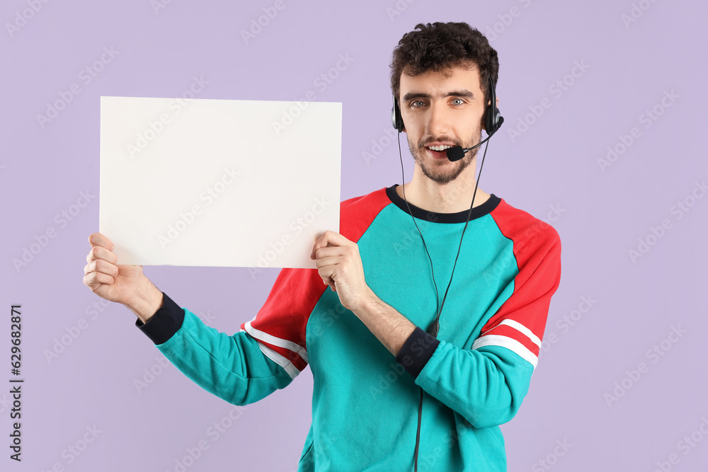 Male technical support agent with blank poster on lilac background