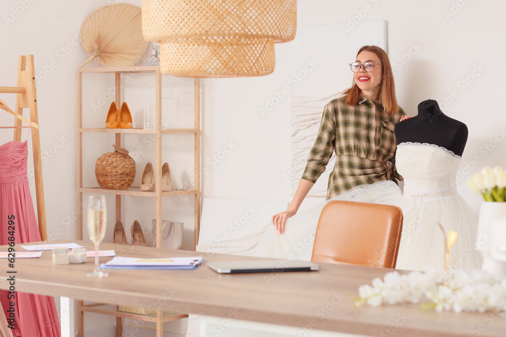 Female wedding planner with dress working in office