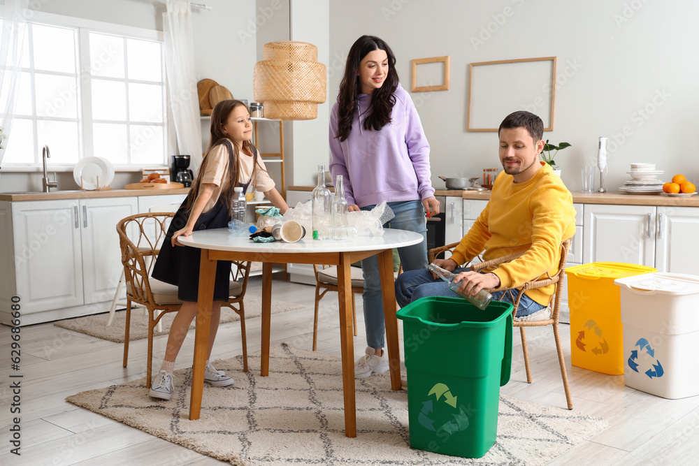 Family sorting garbage with recycle bin in kitchen