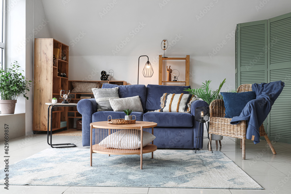 Interior of stylish living room with glowing lamps, sofa and armchair