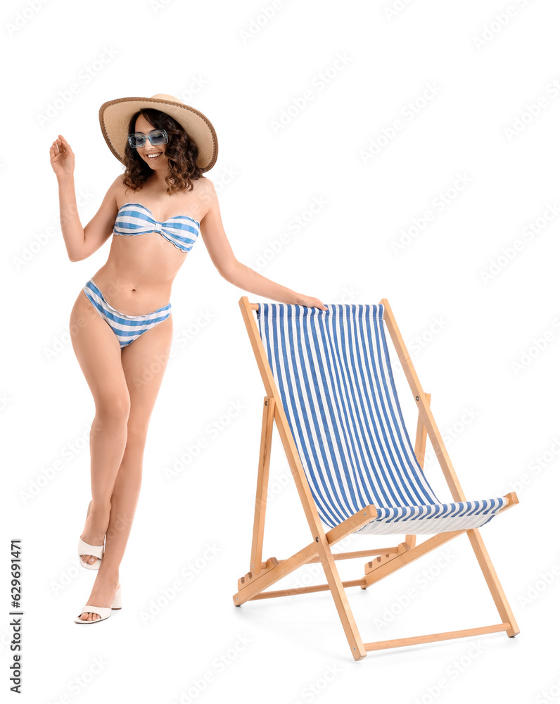 Young woman with deck chair on white background