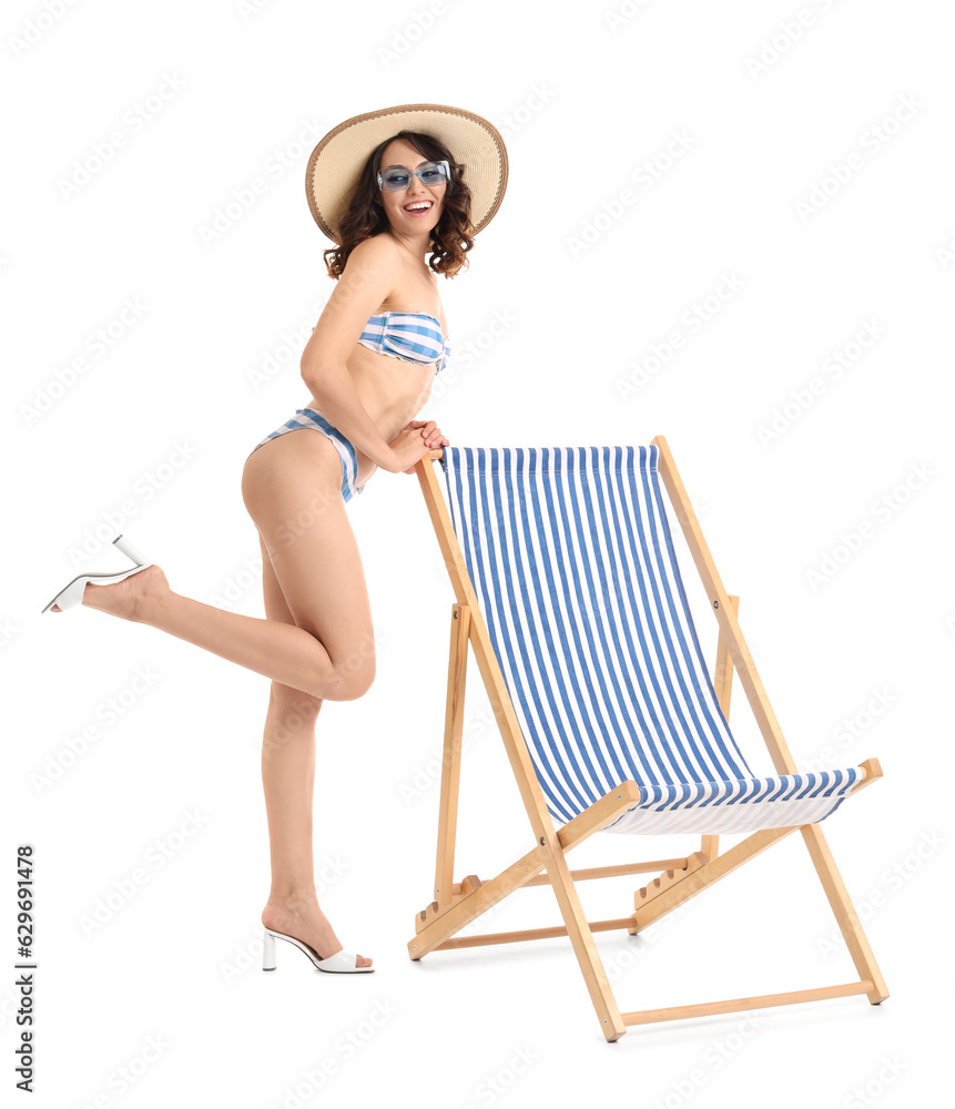 Young woman with deck chair on white background