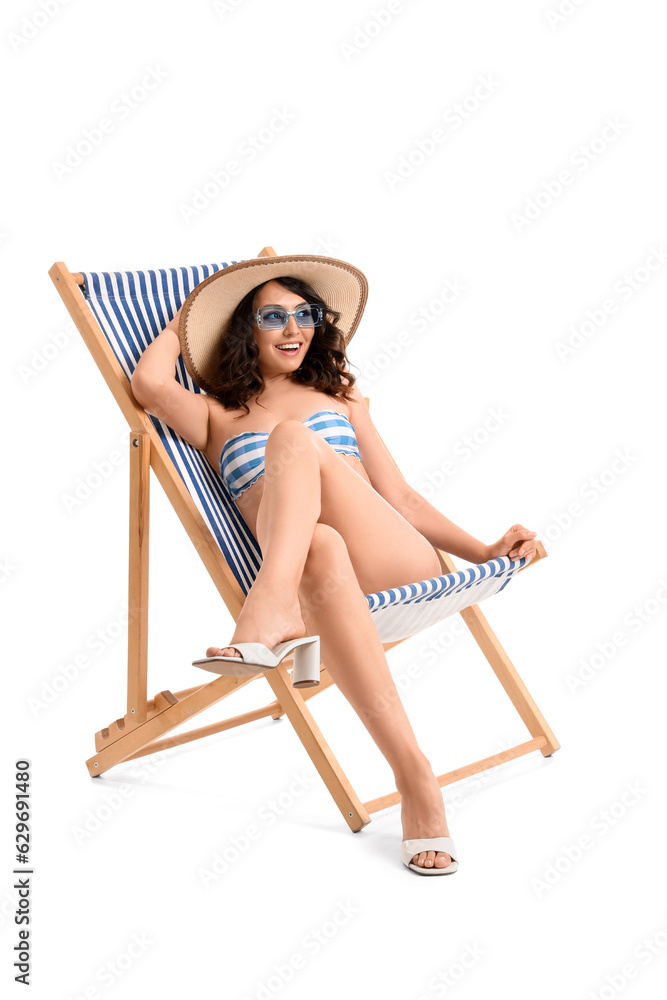 Young woman in deck chair on white background