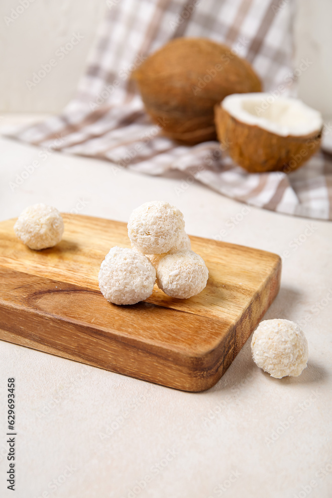 Board with white chocolate coconut candies on light table