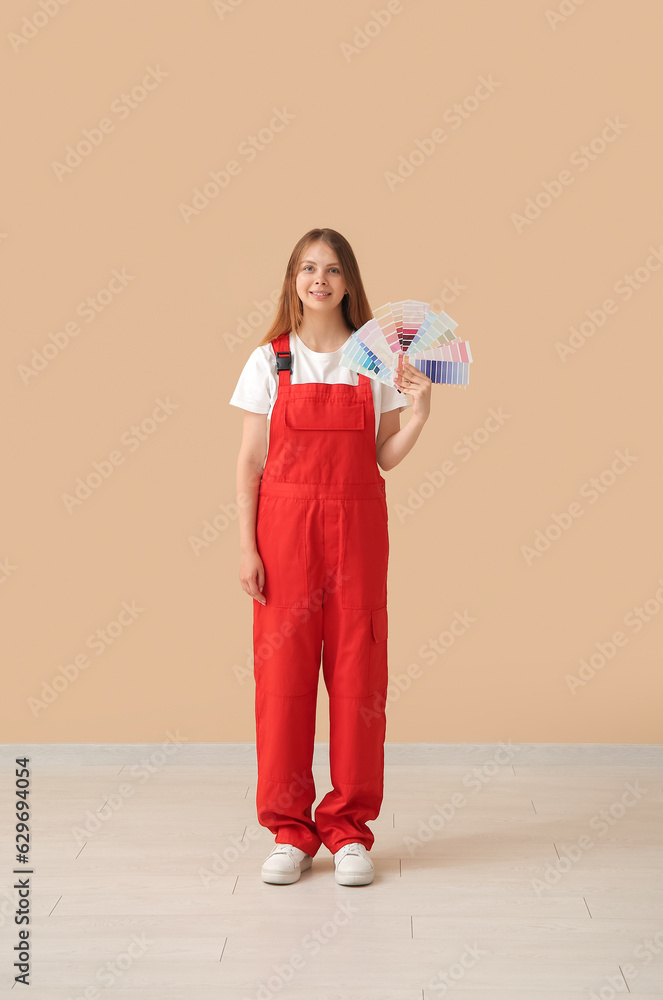 Female decorator with color samples on beige background