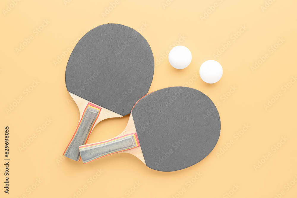 Ping pong rackets and balls on color background