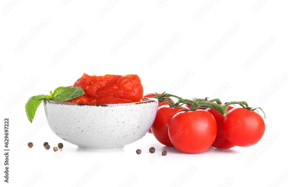 Bowl of canned tomatoes and spices on white background