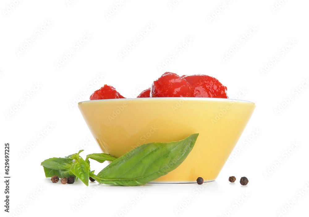 Bowl of canned tomatoes and spices on white background