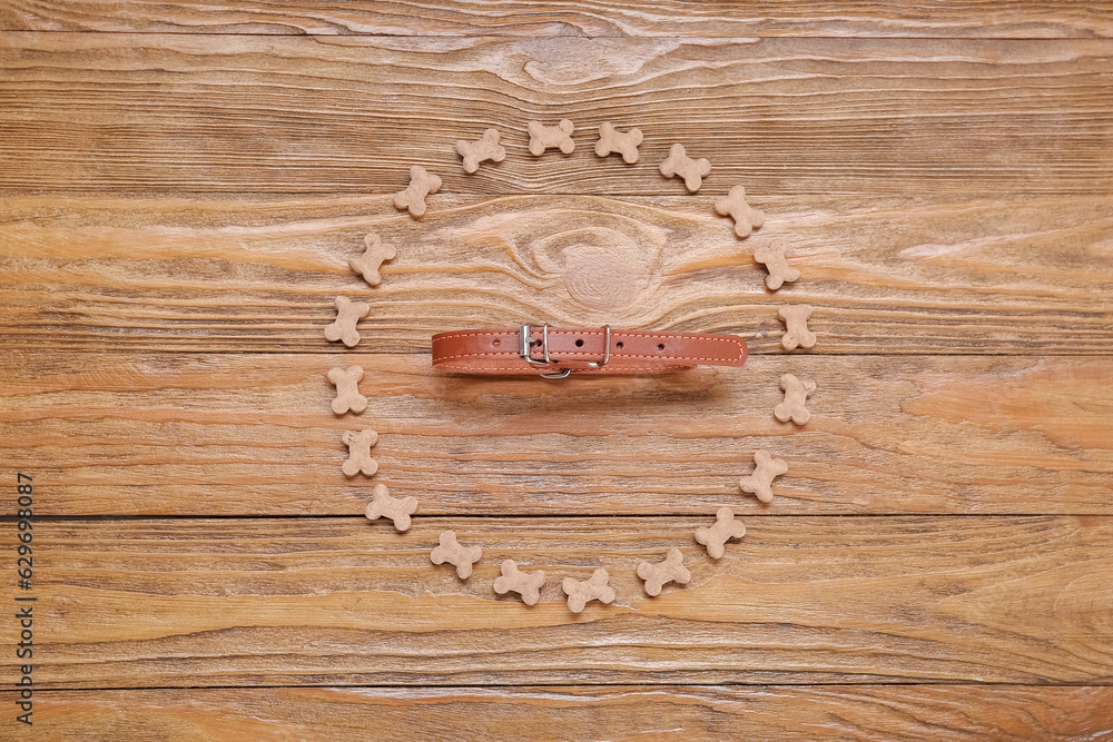 Composition with pet collar and dry food on wooden background