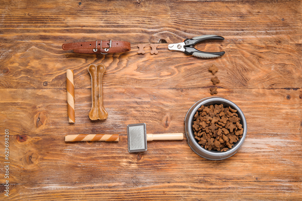 Frame made of different pet food and accessories on wooden background