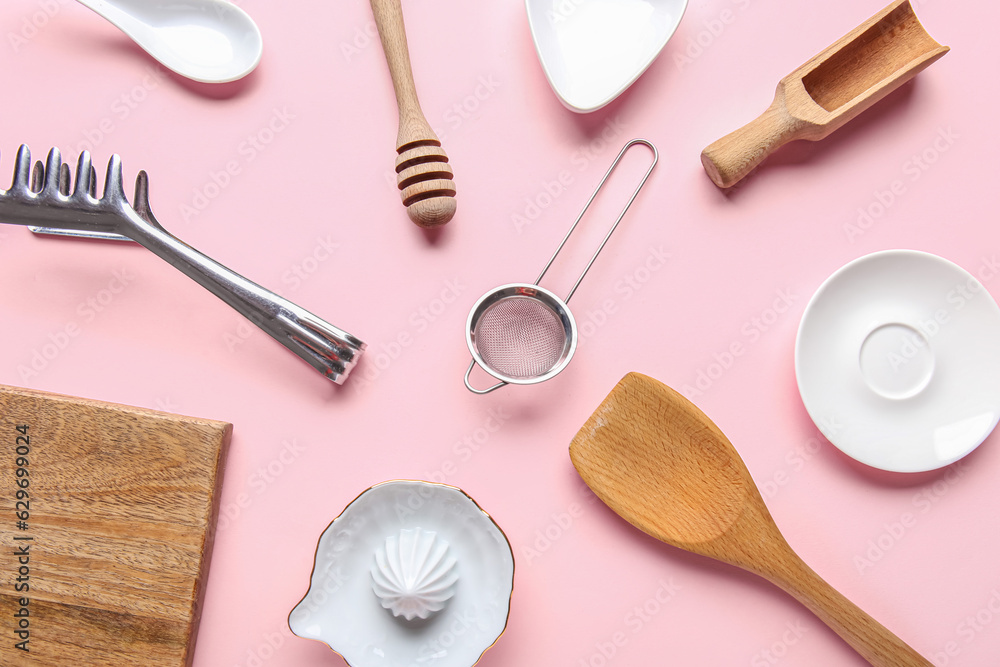 Composition with different kitchen utensils on pink background