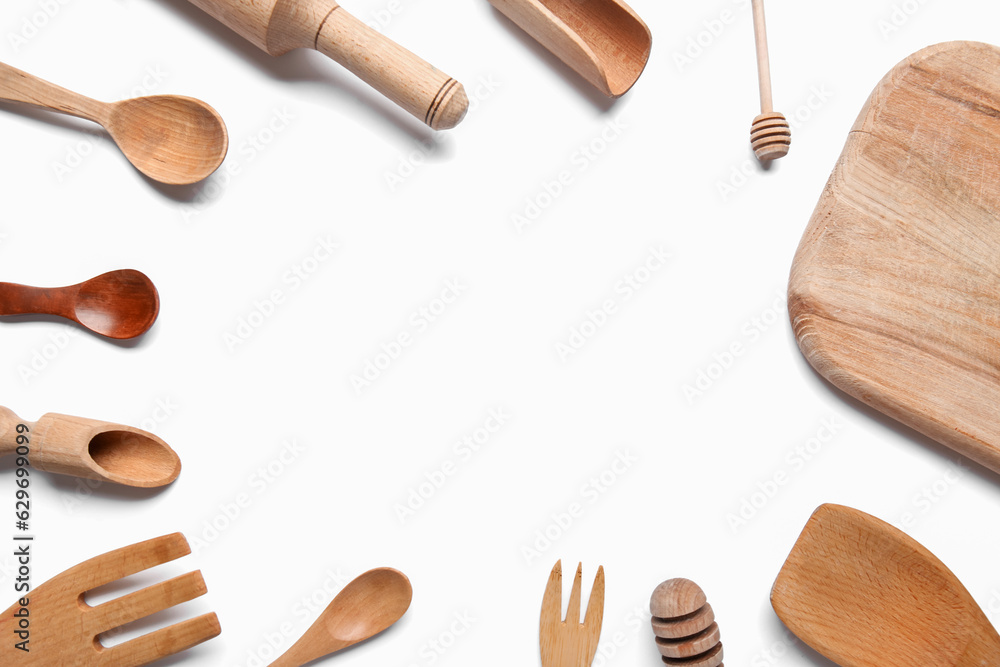 Frame of wooden kitchen utensils on white background