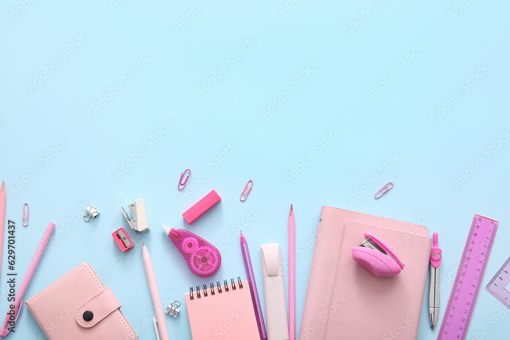 Different school stationery and notebooks on blue background