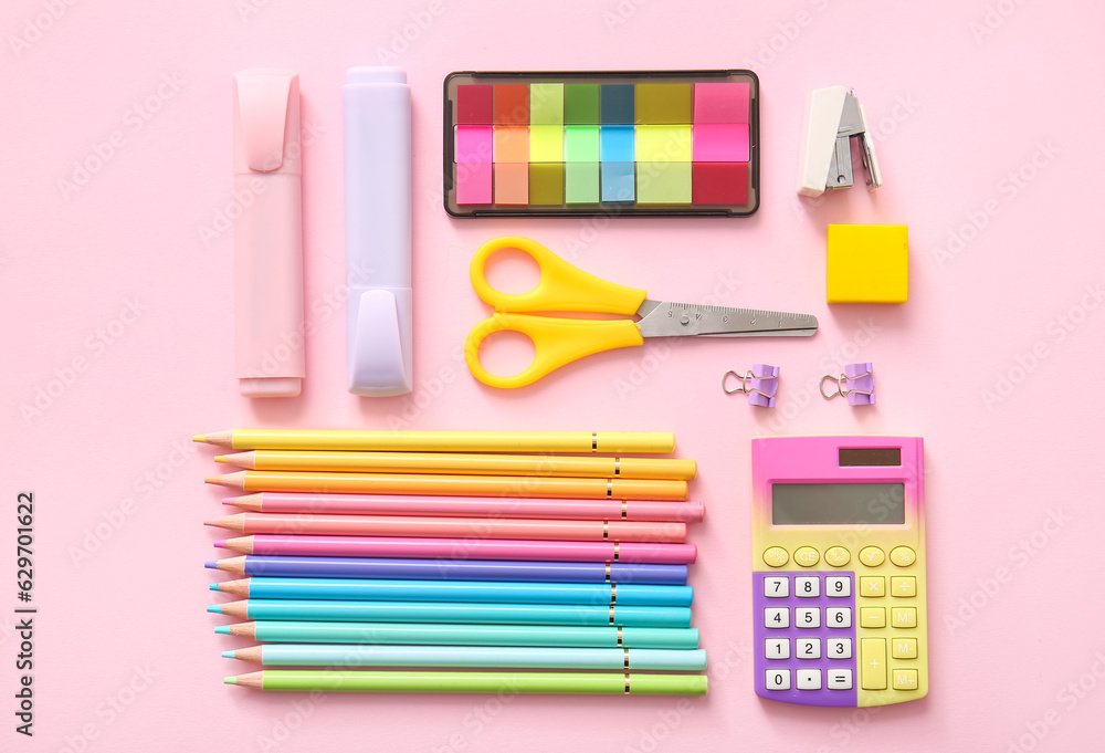 Different school stationery on pink background