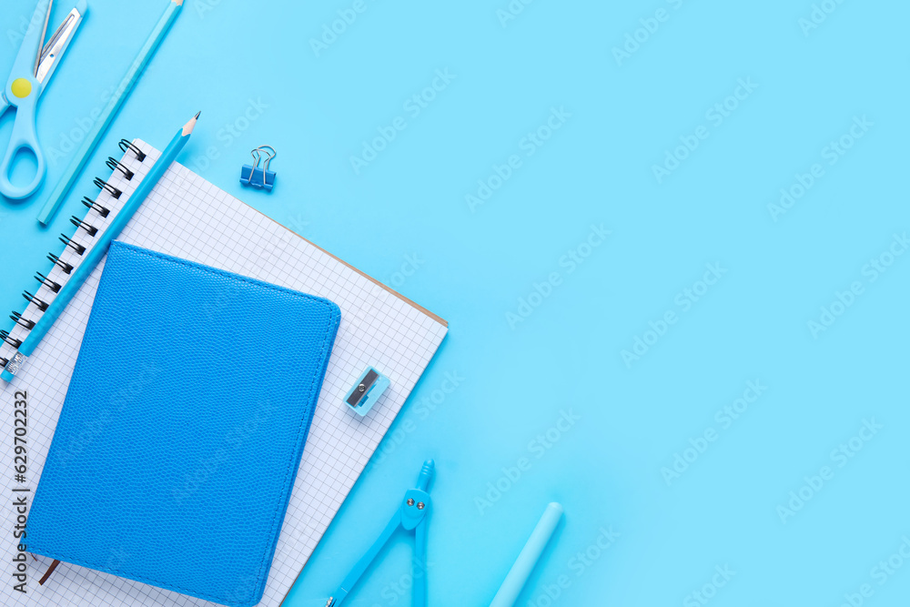 Set of stationery with notebooks on blue background