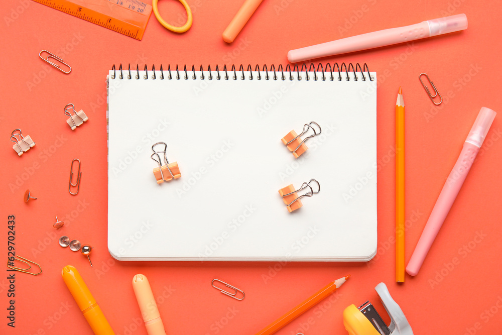 Composition with stationery on red background