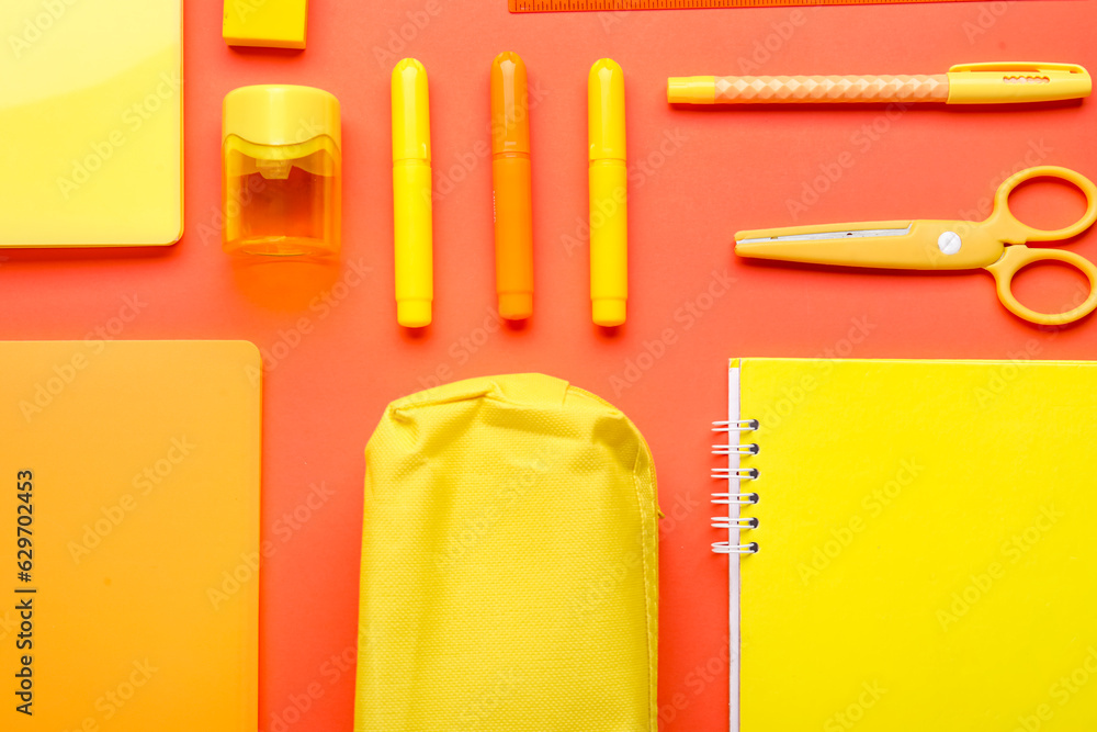 Composition with colorful stationery on red background