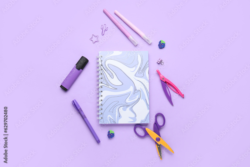 Composition with different stationery on lilac background