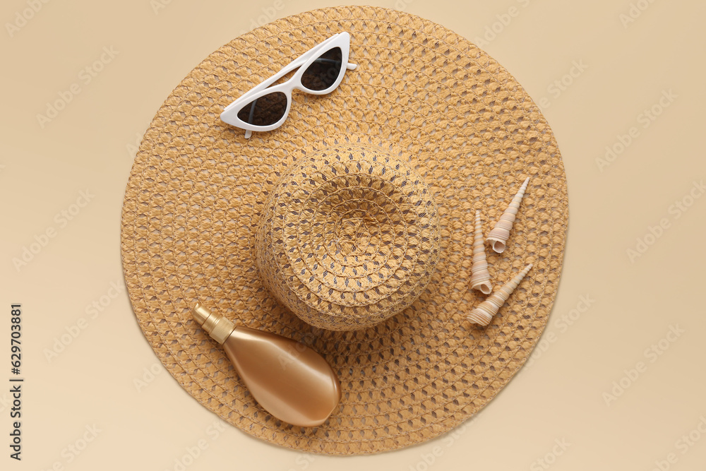 Stylish straw hat, sunglasses and seashells on color background