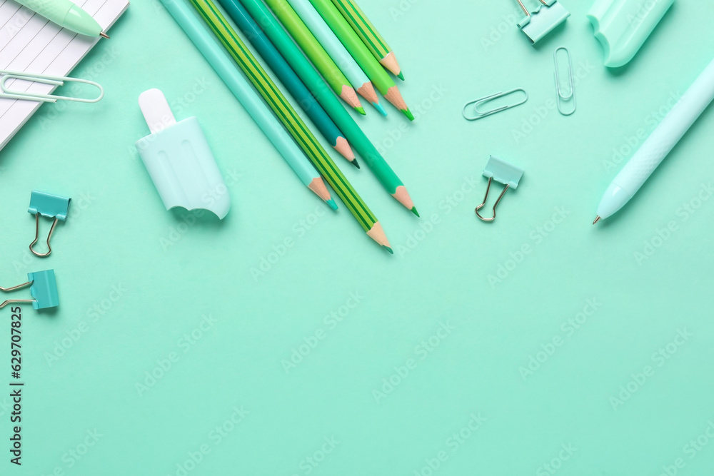 Set of different stationery with pencils on color background